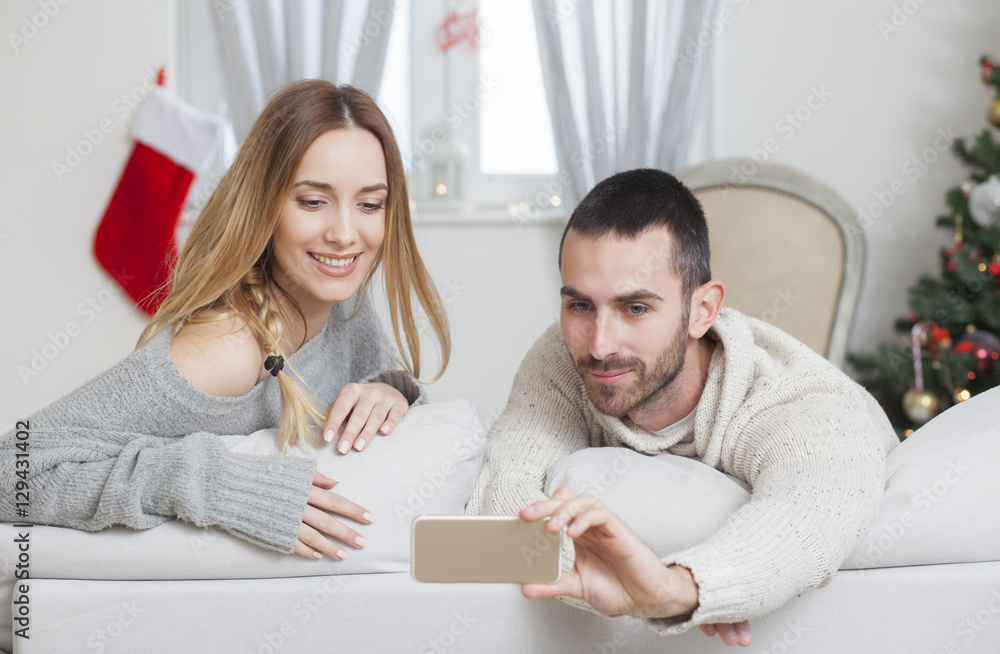 Young couple in love taking selfie on Christmas night Young couple in love taking selfie on Christmas night
