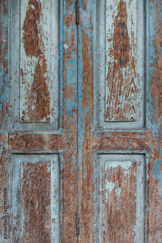 wooden door with flaking blue paint
