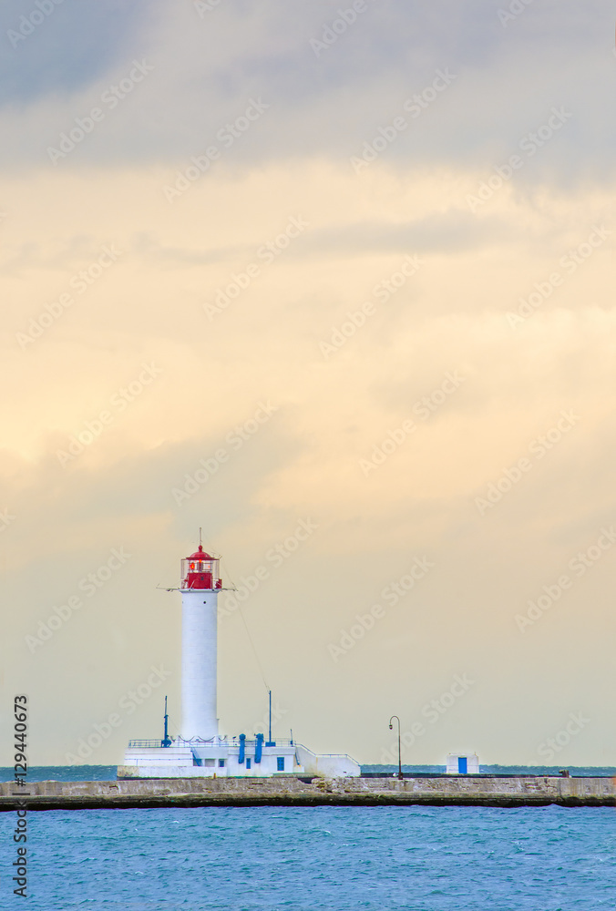 The lighthouse on the background of the cloudy sky The lighthouse on the background of the cloudy sky