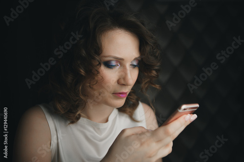 sad woman uses a smartphone