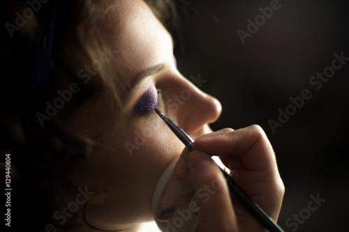 makeup artist  creating makeup in beauty salon