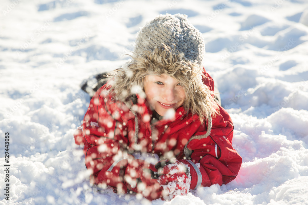 Happy boy playing in snow, winter games Happy boy playing in snow, winter games