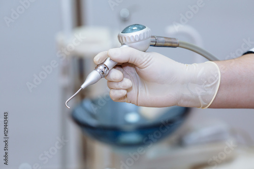 Dentist doctor hand holding medical tools in dental office. Concept of healthy