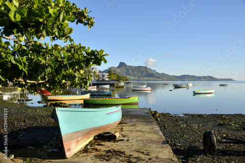 MAHEBOURG, MAURITIUS - View of the fishing landing station with green pirogue