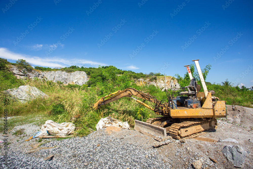 Fototapeta premium yellow backhoe work in field site