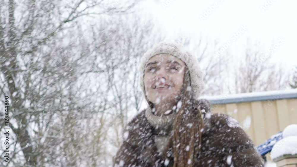 Pretty girl enjoying of snow falling. Slow motion Pretty girl enjoying of snow falling. Slow motion