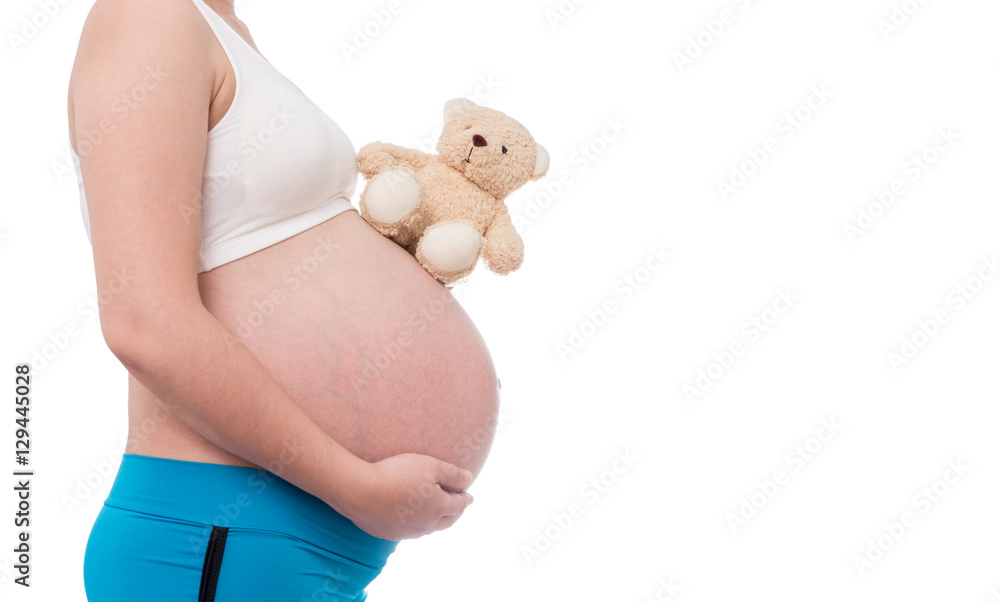 © bunwit - The belly asia pregnant woman holdind a teddy bear doll isolate
