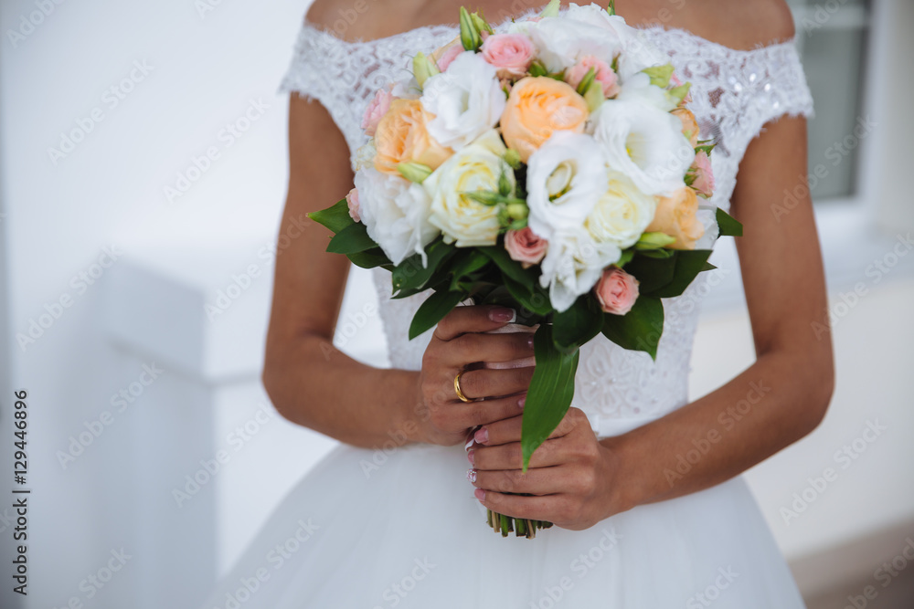 bouquet in the hands of the beautiful bride at wedding day bouquet in the hands of the beautiful bride at wedding day