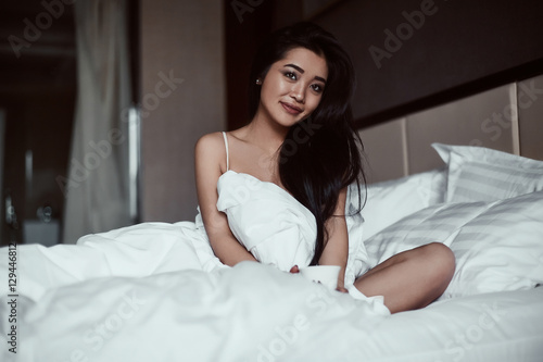 Portrait of a beautiful sensual asian woman with coffee © micro