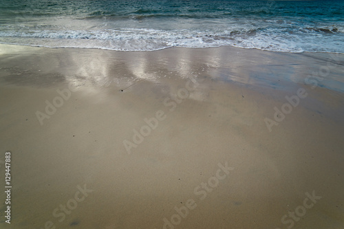 Soft Wave Of Blue Ocean On Sandy Beach. Background. Selective focus.