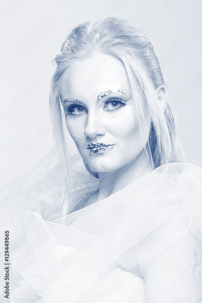 blonde in a white dress with blue makeup. The Snow Queen. blonde in a white dress with blue makeup. The Snow Queen.