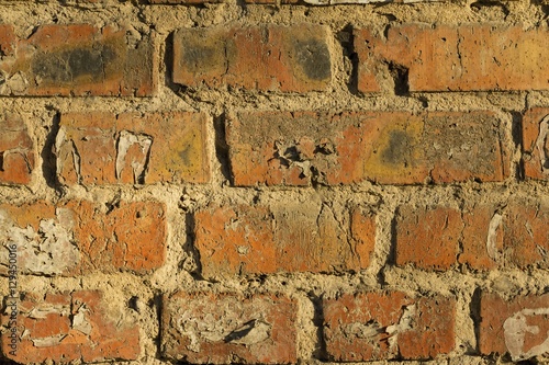 Old brick wall with cracks and scratches. Macro shot.