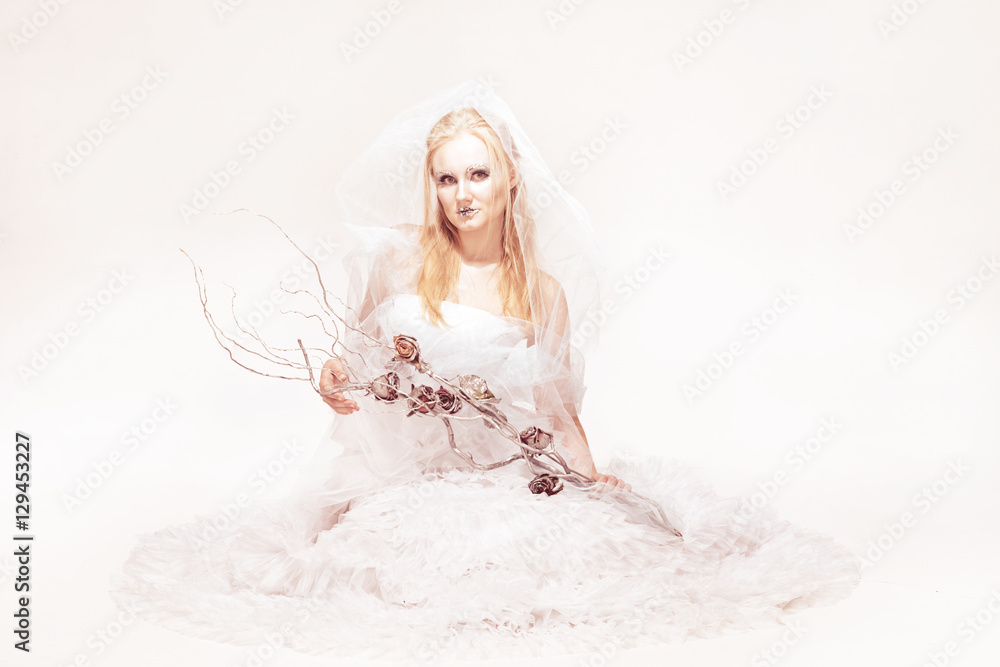 blonde in a white dress with blue makeup. The Snow Queen. blonde in a white dress with blue makeup. The Snow Queen.