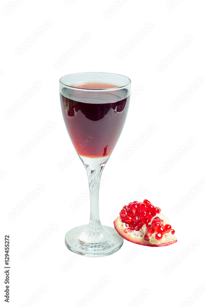 Pomegranate juice in a wine glass and ripe pomegranate Pomegranate juice in a wine glass and ripe pomegranate
