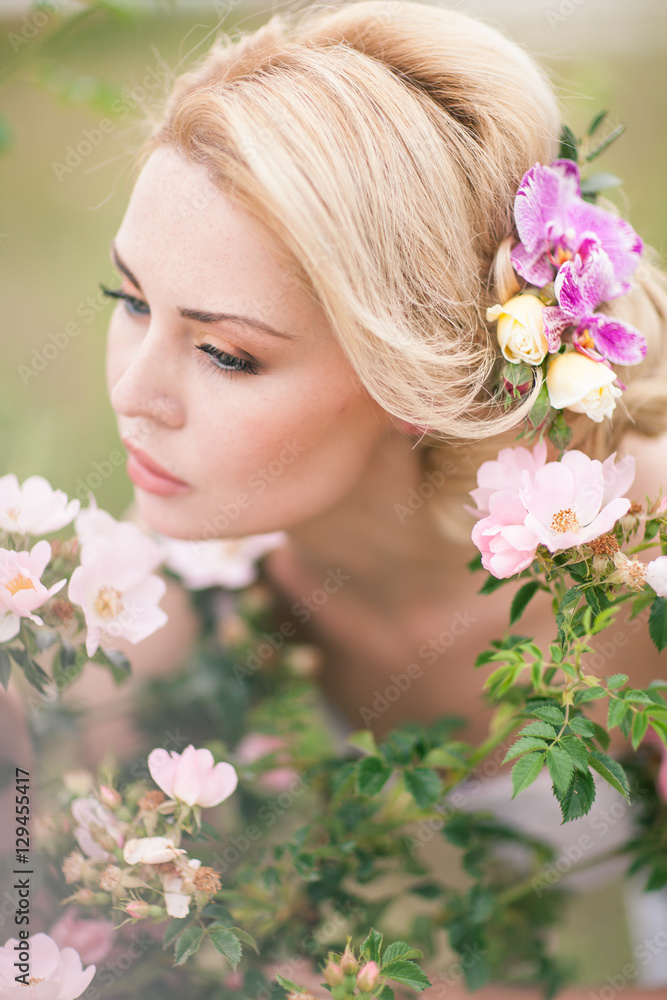 Beautiful Blonde Bride in White Dress with Flowers in her hairst