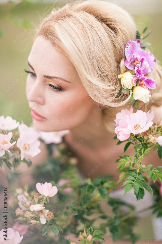 Beautiful Blonde Bride in White Dress with Flowers in her hairst Beautiful Blonde Bride in White Dress with Flowers in her hairst