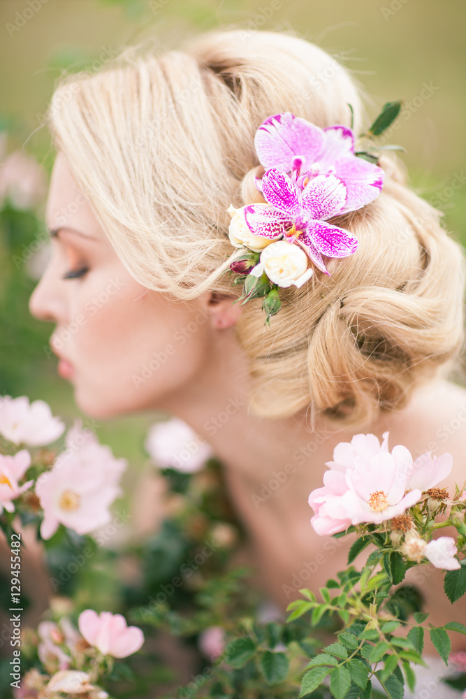 Beautiful Blonde Bride in White Dress with Flowers in her hairst Beautiful Blonde Bride in White Dress with Flowers in her hairst
