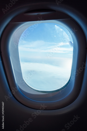 clouds in the aircraft's porthole , selected focus .