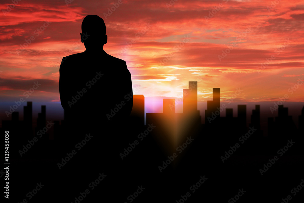 Fototapeta premium silhouette businessman standing looking to the city.