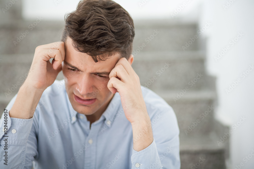 Disappointed businessman sitting on stairs Disappointed businessman sitting on stairs