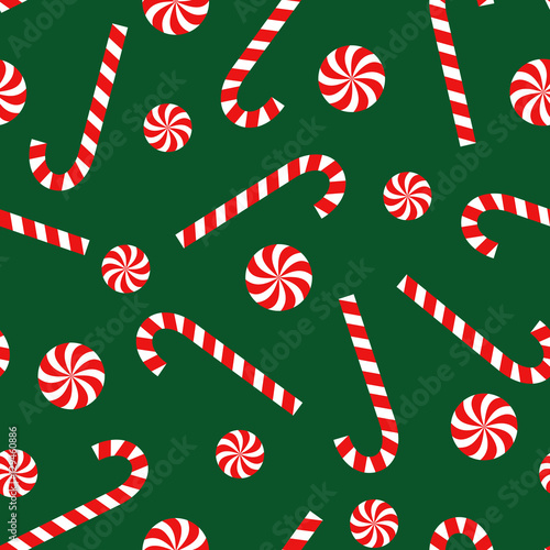 Candy cane and lollipop seamless christmas pattern on green background. Happy New Year and Merry Xmas background. Vector winter holidays print for textile, wallpaper, fabric, wallpaper.
