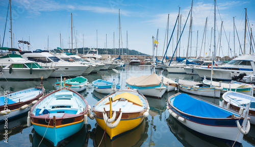 Small boats and yachts docked in the marina of villefranche sur mer near the city of Nice in the south of France 