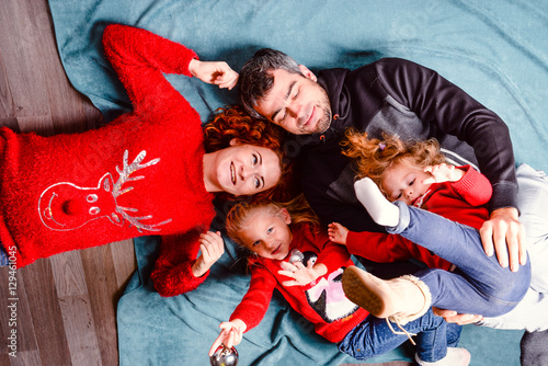 Modern family mother father daughter Christmas winter portrait. christmas tree, cozy atmosphere living room. Family Together Christmas Celebration Concept. Merry Christmas and Happy Holidays. 
