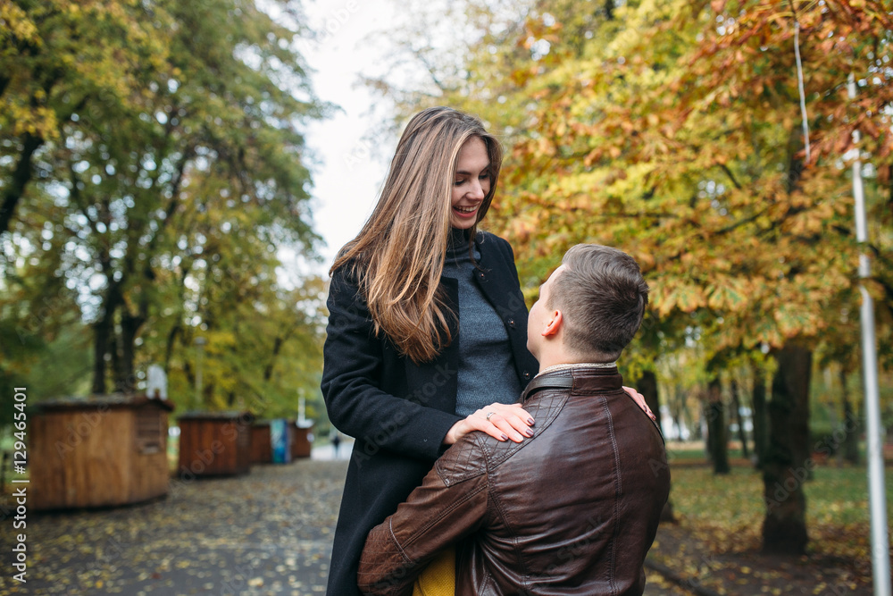 attractive happy couple walking in autumn park attractive happy couple walking in autumn park
