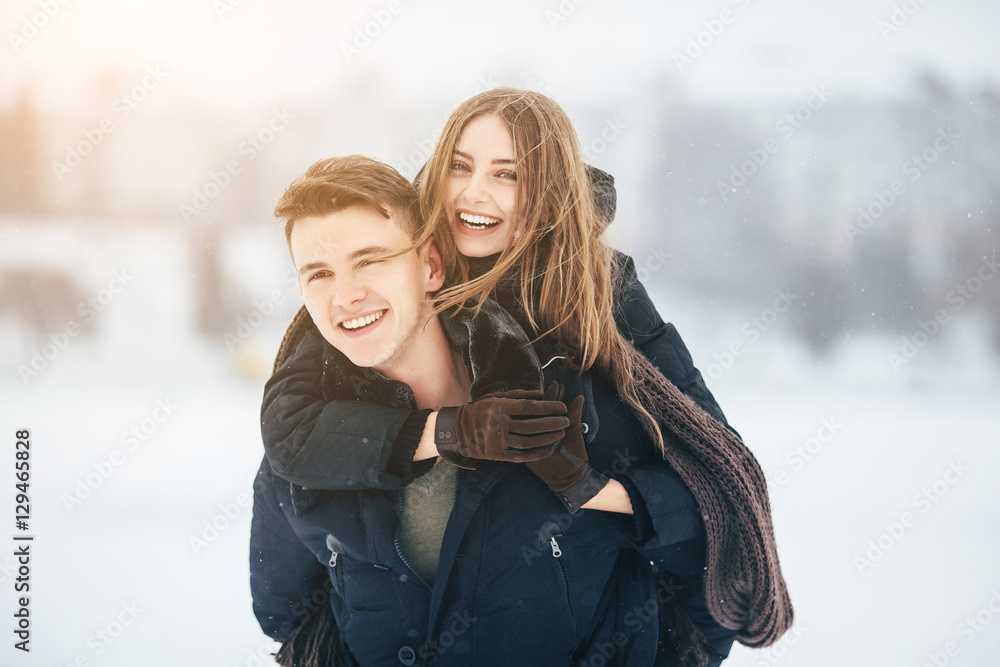 man carries his girlfriend on the back man carries his girlfriend on the back