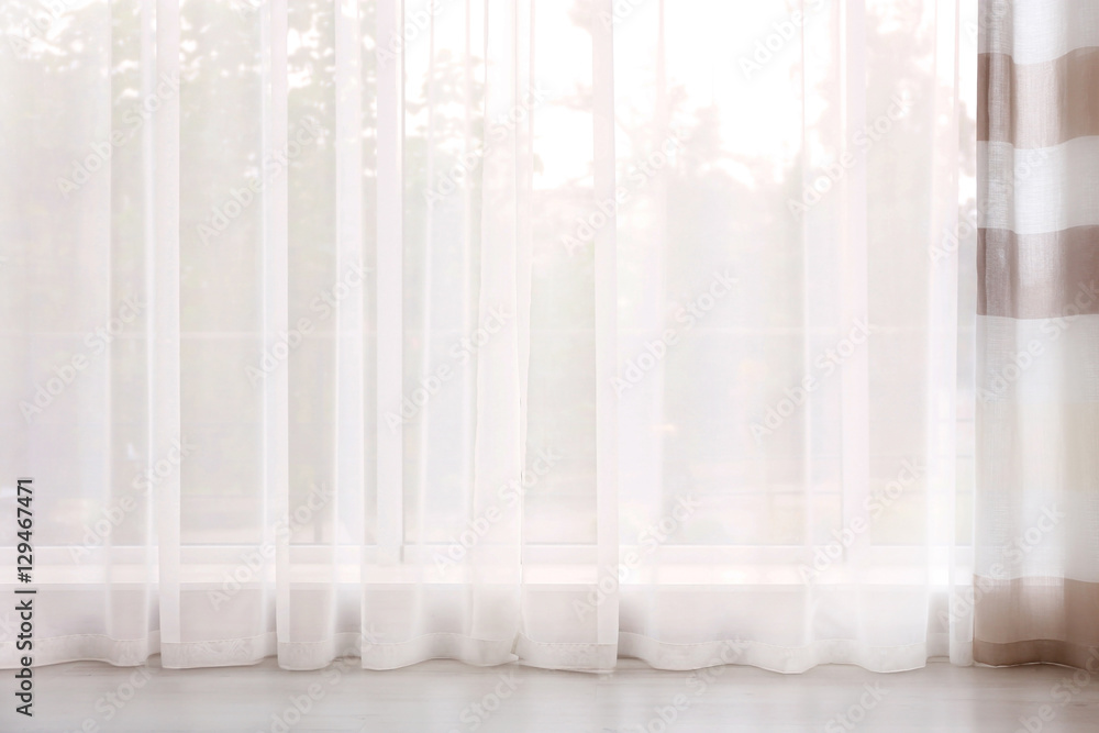 New elegant curtain on window New elegant curtain on window