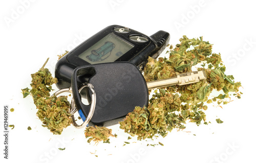 Driving high, marijuana and car key isolated on white photo