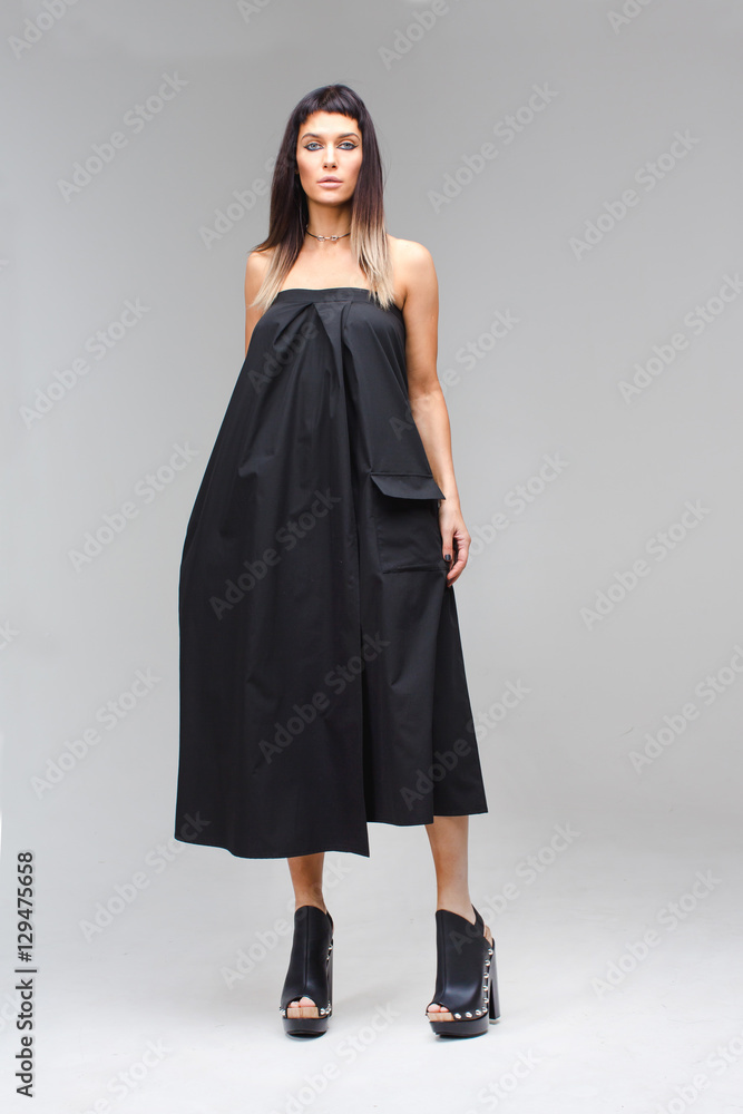 Model which holds the dress in hand black sundress Model which holds the dress in hand black sundress