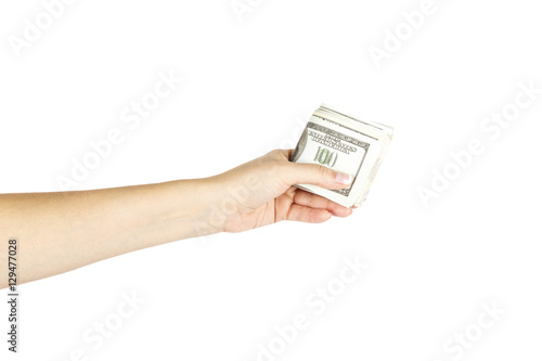 Female's hand holds stack of dollars on white background.