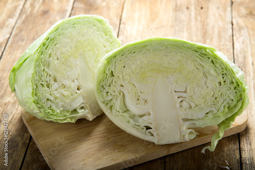 Cut savoy cabbage on wooden cutting board 