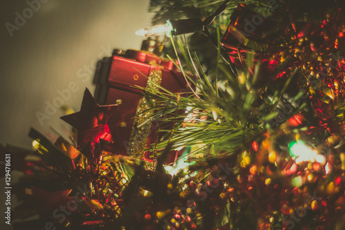 Red Gift box on Christmas Tree blurrd background photo