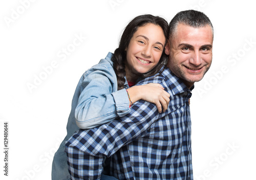 Father standing and carrying girl on his back