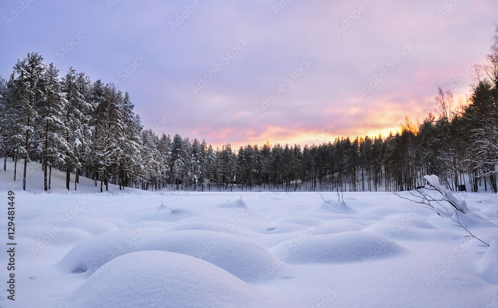 Winter landscape. Frozen lake. Snowdrifts. Sunset Winter landscape. Frozen lake. Snowdrifts. Sunset