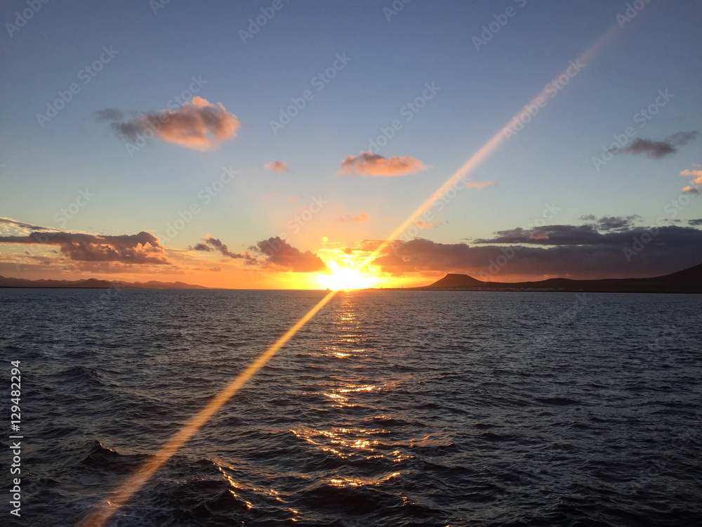 Sunset sailing between La Graciosa Island and Lanzarote (Canary Islands, Spain)