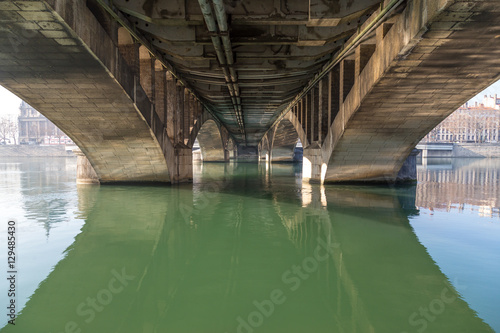 Under a bridge with a river