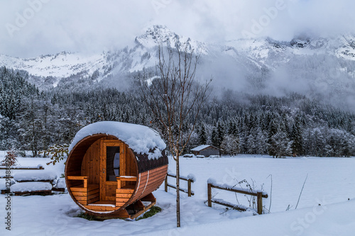 Wooden sauna in a snowy landscape  photo