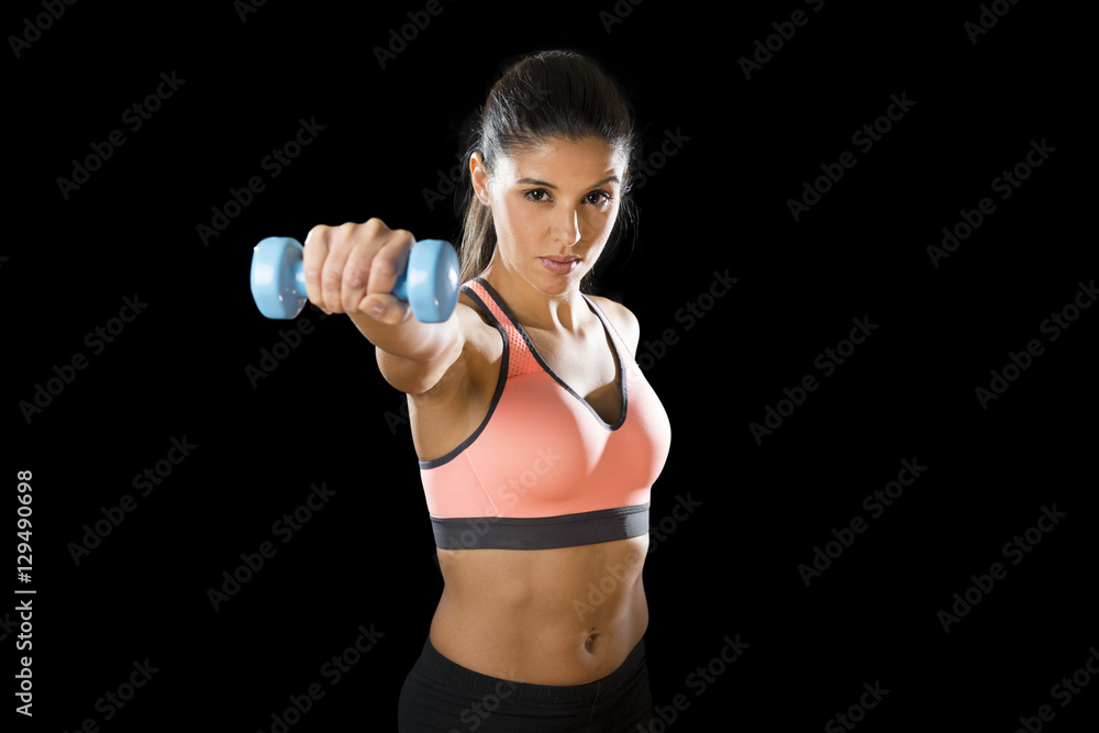latin sport woman posing in fierce expression holding dumbbell hand weigh latin sport woman posing in fierce expression holding dumbbell hand weigh