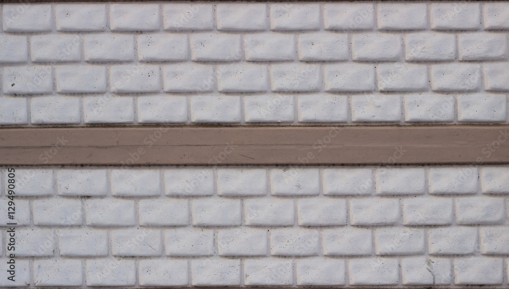 Wall made of decorative stone blocks painted in white