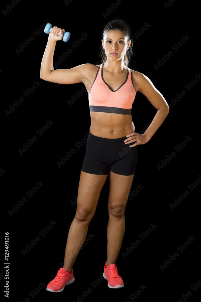latin sport woman posing in fierce expression holding dumbbell hand weigh latin sport woman posing in fierce expression holding dumbbell hand weigh