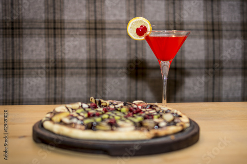 Red cocktail and the sweet pizza - Stock image