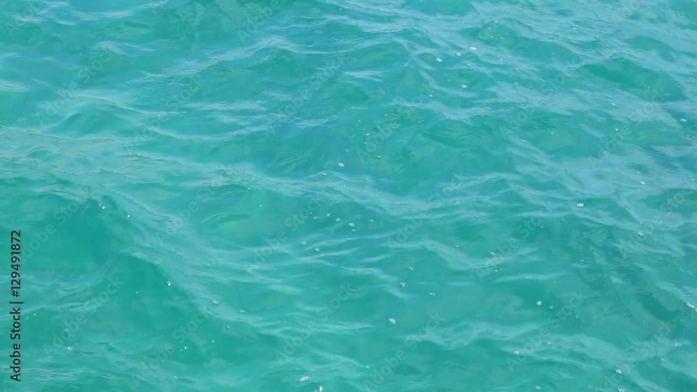 Aquamarine color nature background. Close up of sea water surface of bright blue color on sunny summer day. Real time full hd video footage. Aquamarine color nature background. Close up of sea water surface of bright blue color on sunny summer day. Real time full hd video footage.