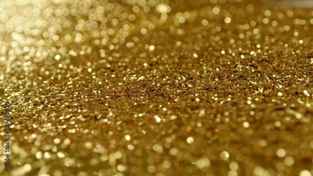 Golden glitter dynamic movements in slow motion Golden glitter dynamic movements in slow motion