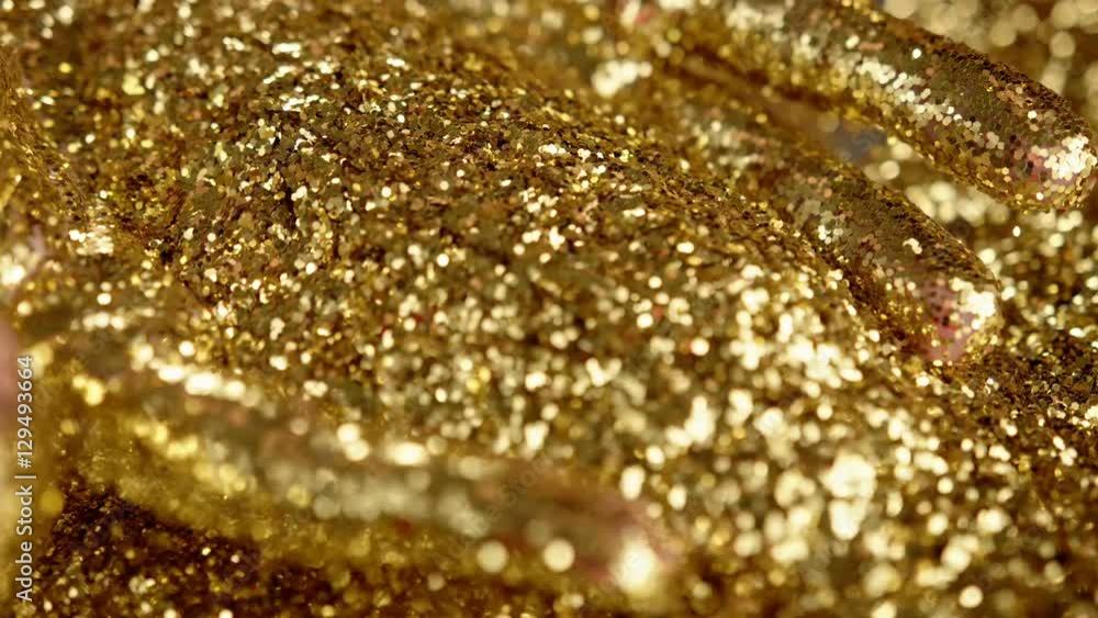 Golden glitter dynamic movements in slow motion Golden glitter dynamic movements in slow motion