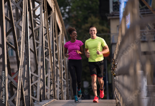 multiethnic couple jogging in the city