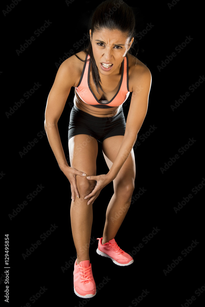  sport woman holding injured knee suffering pain in ligaments injury or pulled muscle