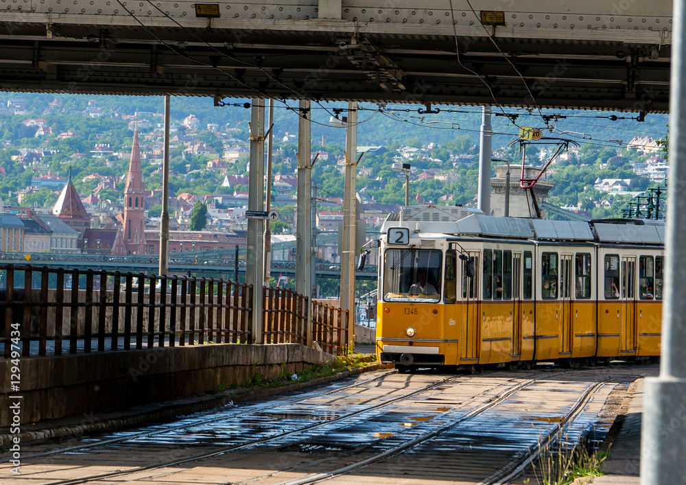 Yellow tram in central Budapest sunny day